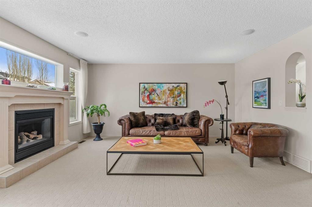 98 Cougarstone Close Sw, Calgary, AB - Indoor Photo Showing Living Room With Fireplace