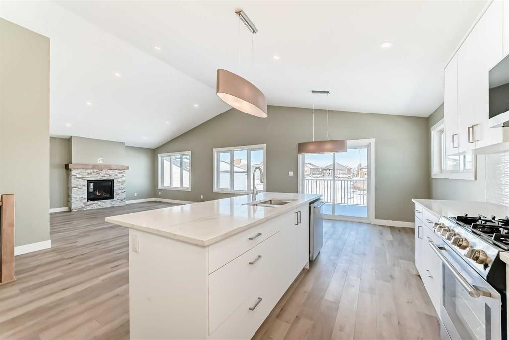 2017 30 Avenue, Nanton, AB - Indoor Photo Showing Kitchen With Fireplace With Upgraded Kitchen