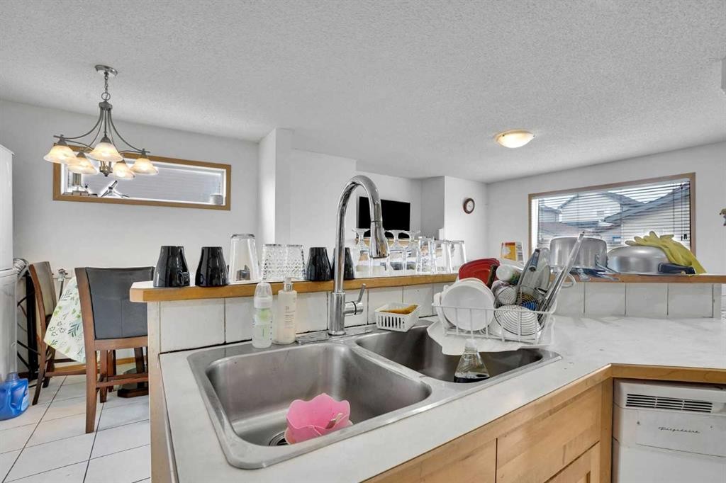 162 Taradale Drive Ne, Calgary, AB - Indoor Photo Showing Kitchen With Double Sink