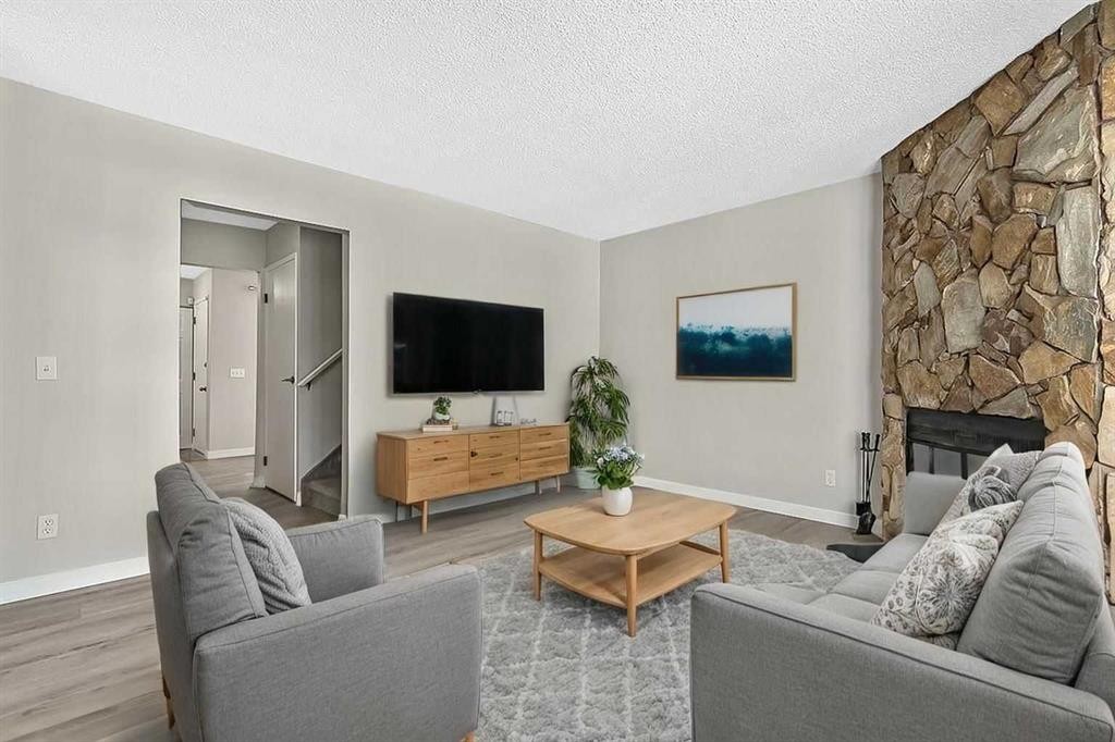 129 Berwick Drive Nw, Calgary, AB - Indoor Photo Showing Living Room With Fireplace