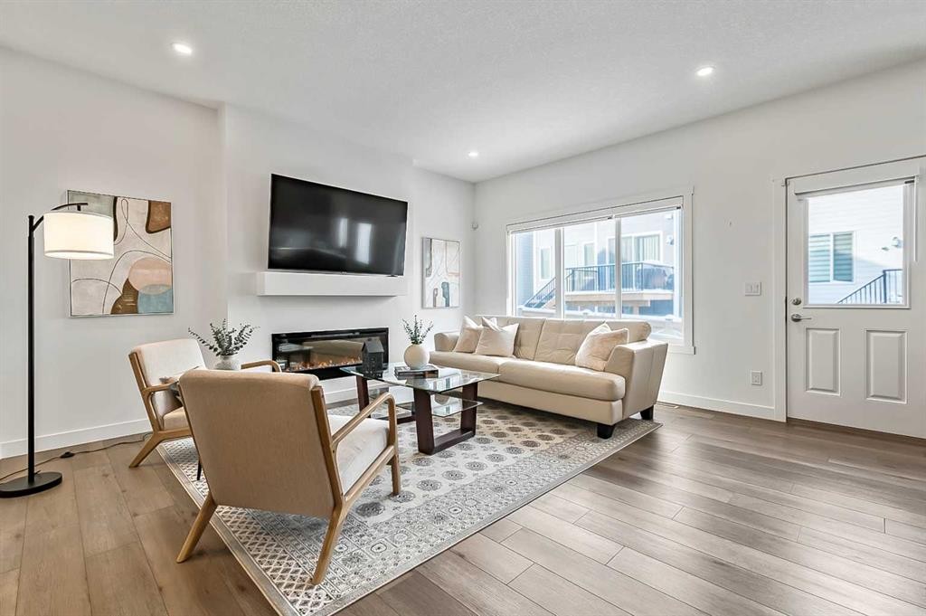 882 Bluerock Way Sw, Calgary, AB - Indoor Photo Showing Living Room With Fireplace