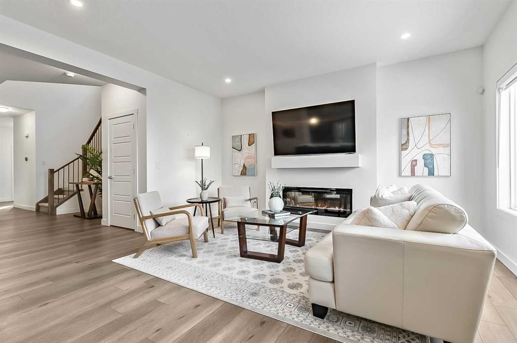 882 Bluerock Way Sw, Calgary, AB - Indoor Photo Showing Living Room With Fireplace