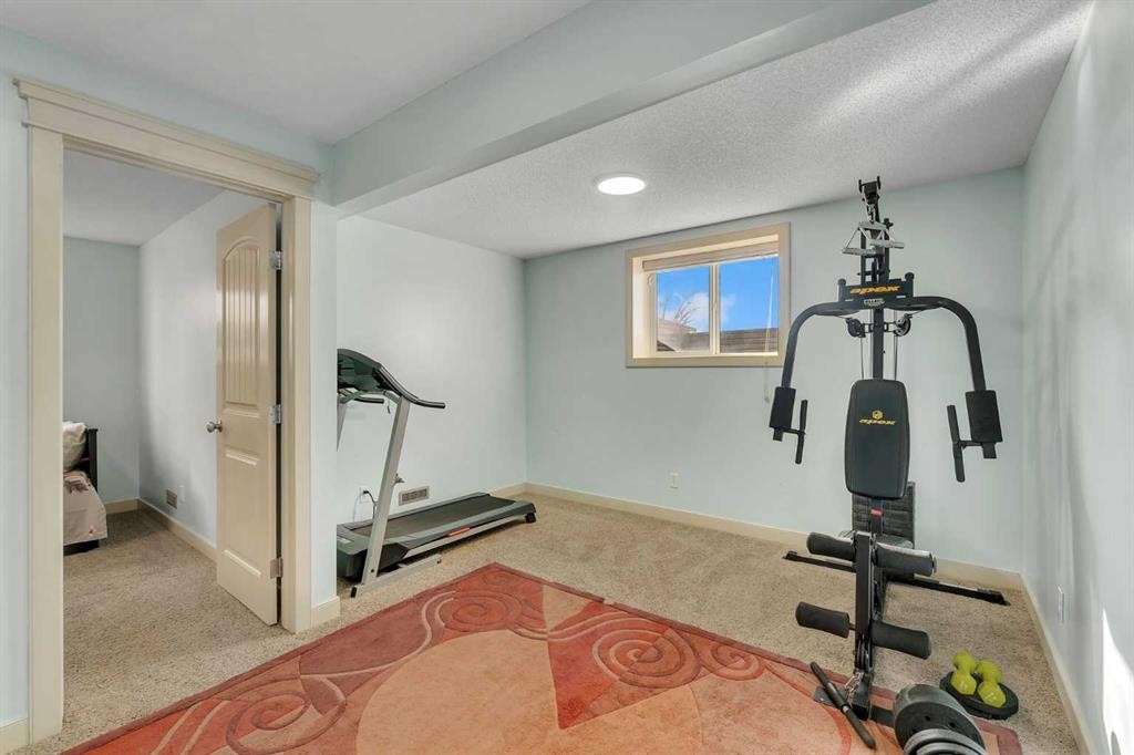 156 Bishop Crescent Nw, Langdon, AB - Indoor Photo Showing Gym Room