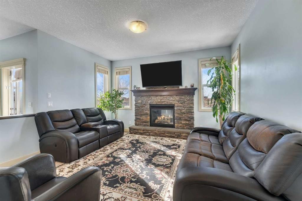 156 Bishop Crescent Nw, Langdon, AB - Indoor Photo Showing Living Room With Fireplace