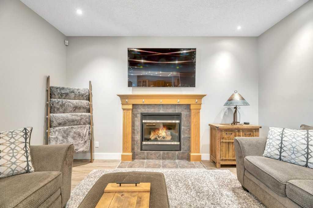 392 Rainbow Falls Way, Chestermere, AB - Indoor Photo Showing Living Room With Fireplace