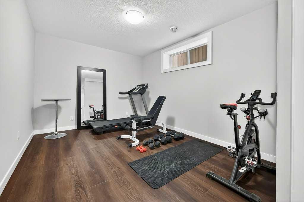 92 Fireside Crescent, Cochrane, AB - Indoor Photo Showing Gym Room
