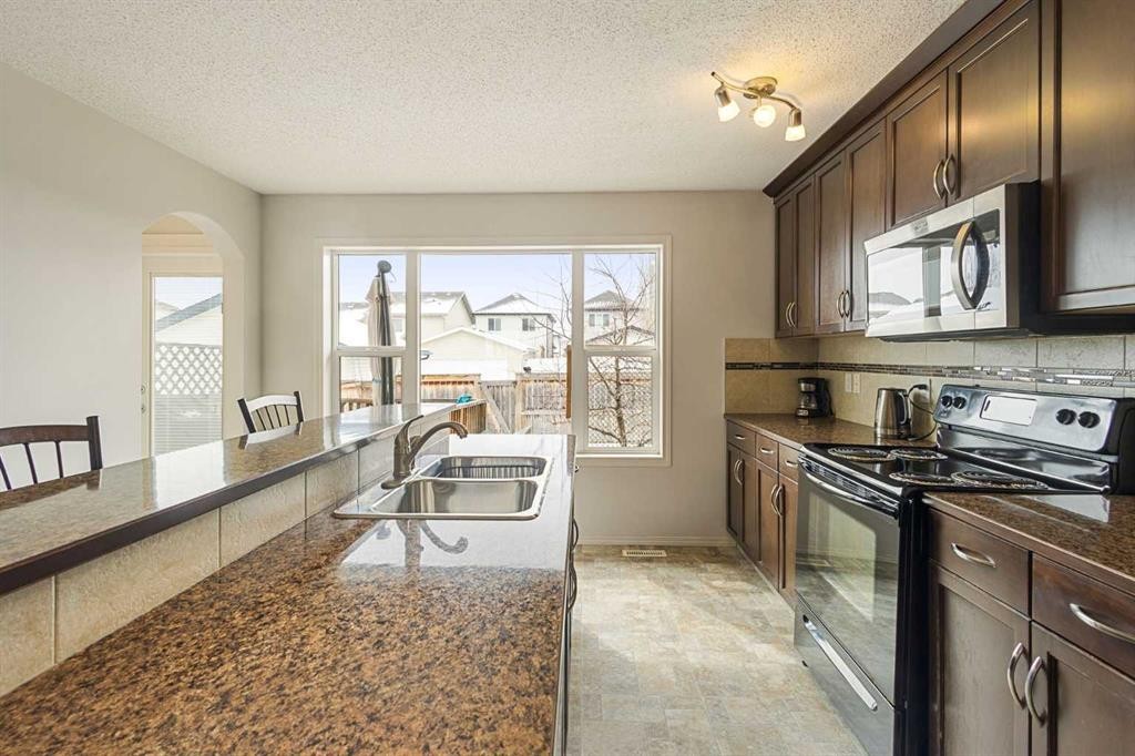 41 Silverado Saddle Avenue Sw, Calgary, AB - Indoor Photo Showing Kitchen With Double Sink