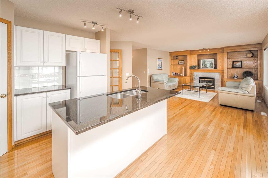 110 Hampstead Rise Nw, Calgary, AB - Indoor Photo Showing Kitchen With Fireplace With Double Sink