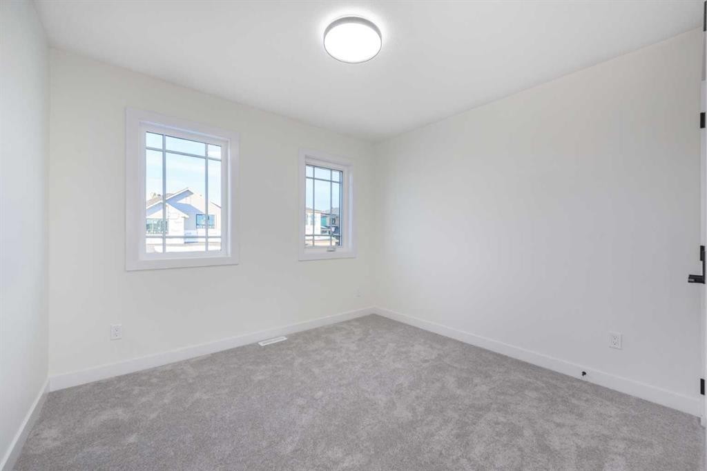 80 Heritage Manor, Cochrane, AB - Indoor Photo Showing Other Room