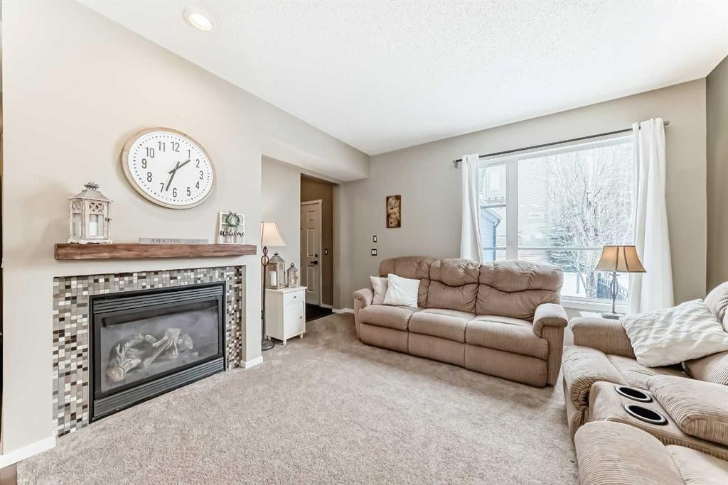 63 Chapalina Square Se, Calgary, AB - Indoor Photo Showing Living Room With Fireplace