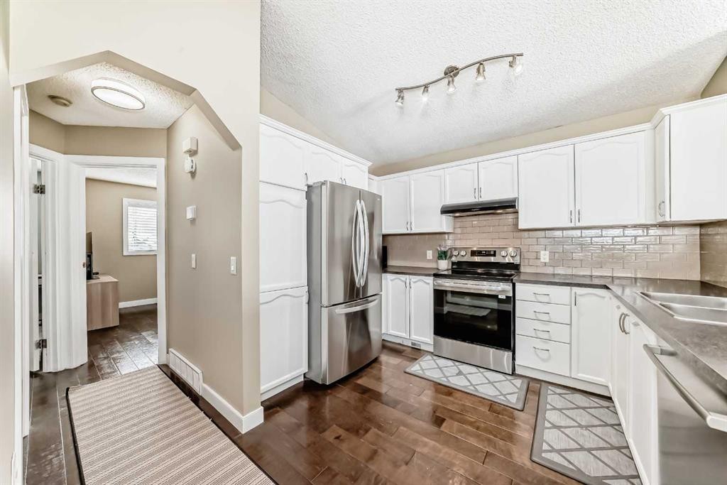 67 Bridleglen Manor Sw, Calgary, AB - Indoor Photo Showing Kitchen With Stainless Steel Kitchen With Double Sink With Upgraded Kitchen