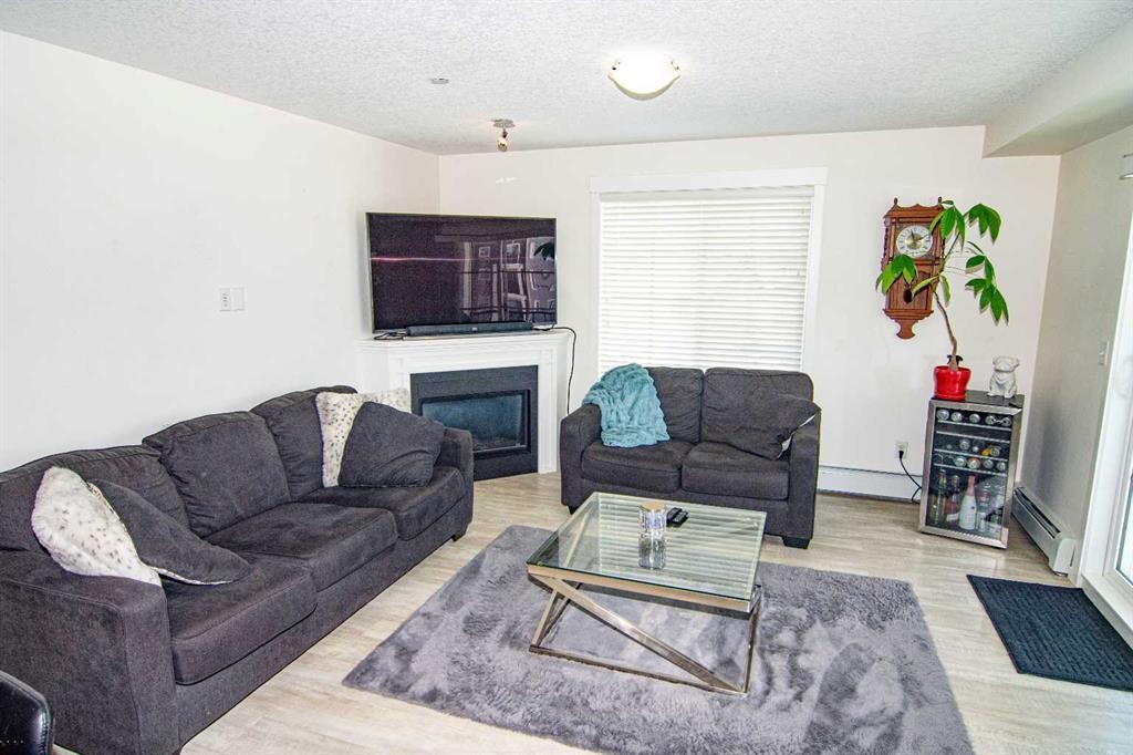 4311-99 Copperstone Park, Calgary, AB - Indoor Photo Showing Living Room With Fireplace
