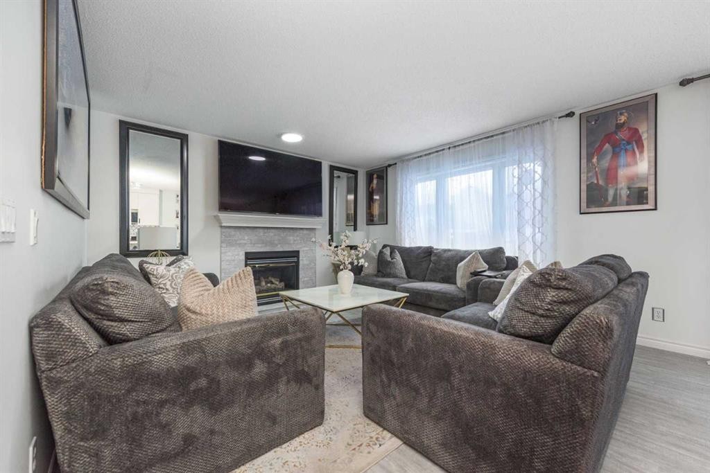 8430 Saddleridge Drive Ne, Calgary, AB - Indoor Photo Showing Living Room With Fireplace