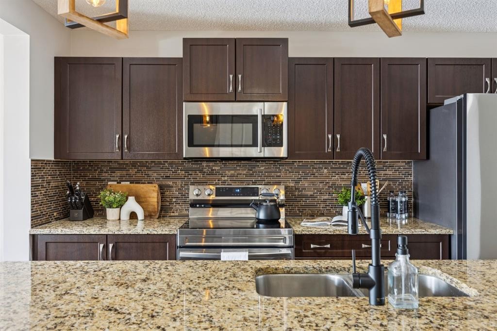 298 River Heights Crescent, Cochrane, AB - Indoor Photo Showing Kitchen With Stainless Steel Kitchen With Double Sink With Upgraded Kitchen
