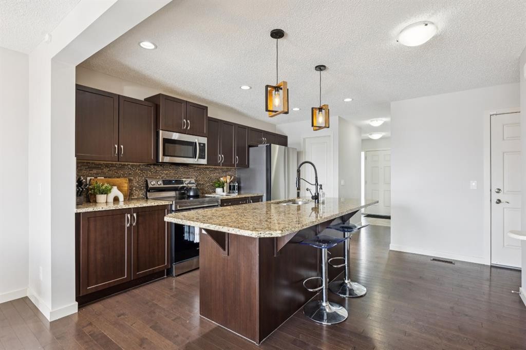 298 River Heights Crescent, Cochrane, AB - Indoor Photo Showing Kitchen With Upgraded Kitchen