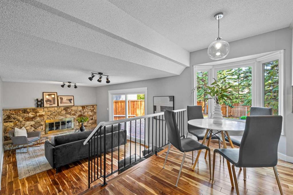 308 Parkridge Green Se, Calgary, AB - Indoor Photo Showing Dining Room With Fireplace