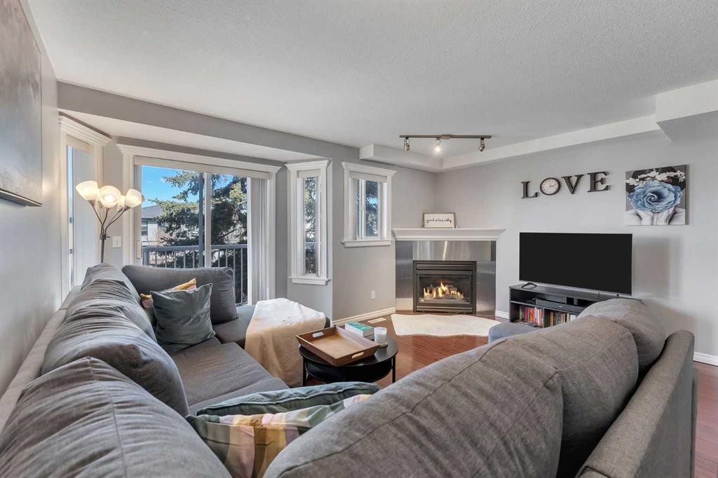201-215 17 Avenue Ne, Calgary, AB - Indoor Photo Showing Living Room With Fireplace