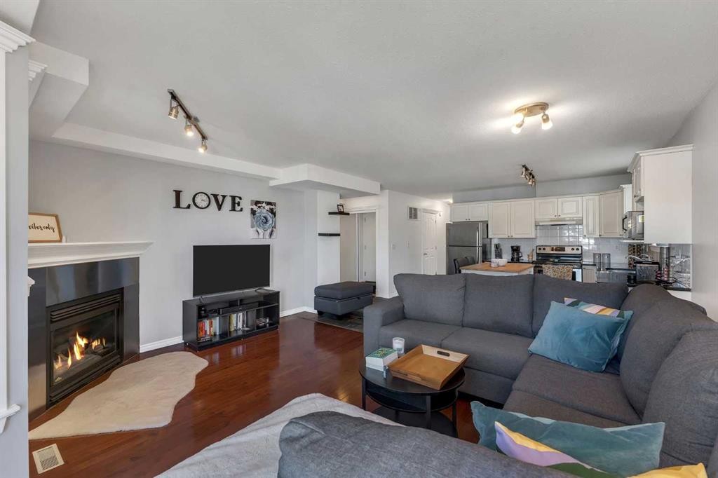 201-215 17 Avenue Ne, Calgary, AB - Indoor Photo Showing Living Room With Fireplace