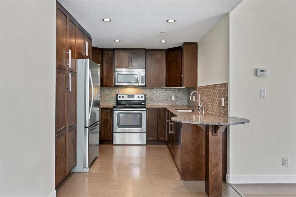 310-16 Varsity Estates Circle Nw, Calgary, AB - Indoor Photo Showing Kitchen With Stainless Steel Kitchen With Double Sink With Upgraded Kitchen