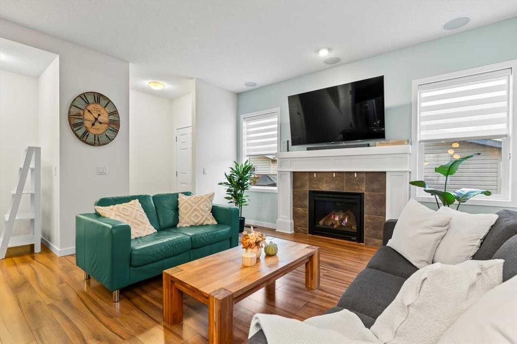 1303 New Brighton Park Se, Calgary, AB - Indoor Photo Showing Living Room With Fireplace