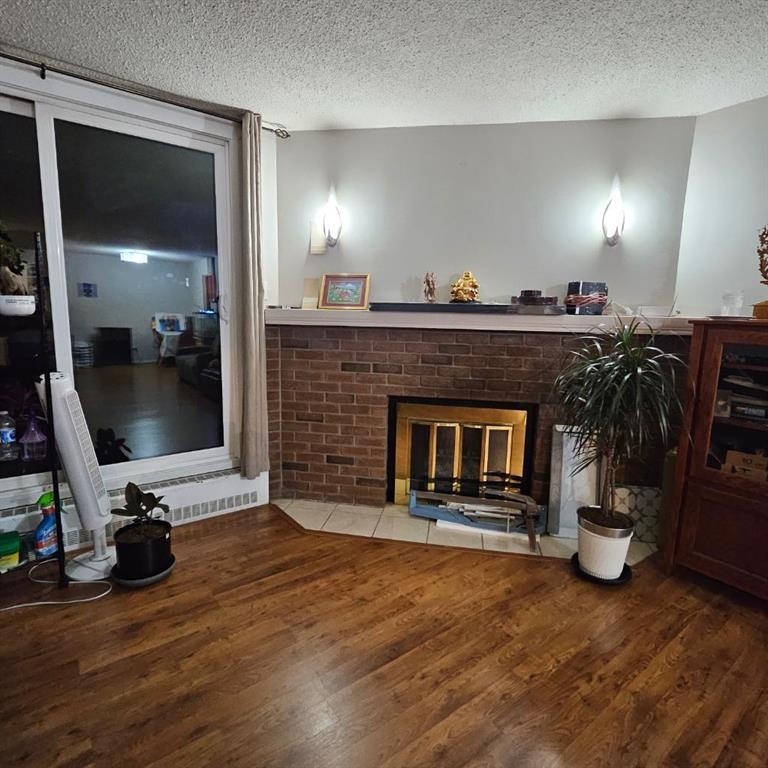 203-511 56 Avenue Sw, Calgary, AB - Indoor Photo Showing Living Room With Fireplace
