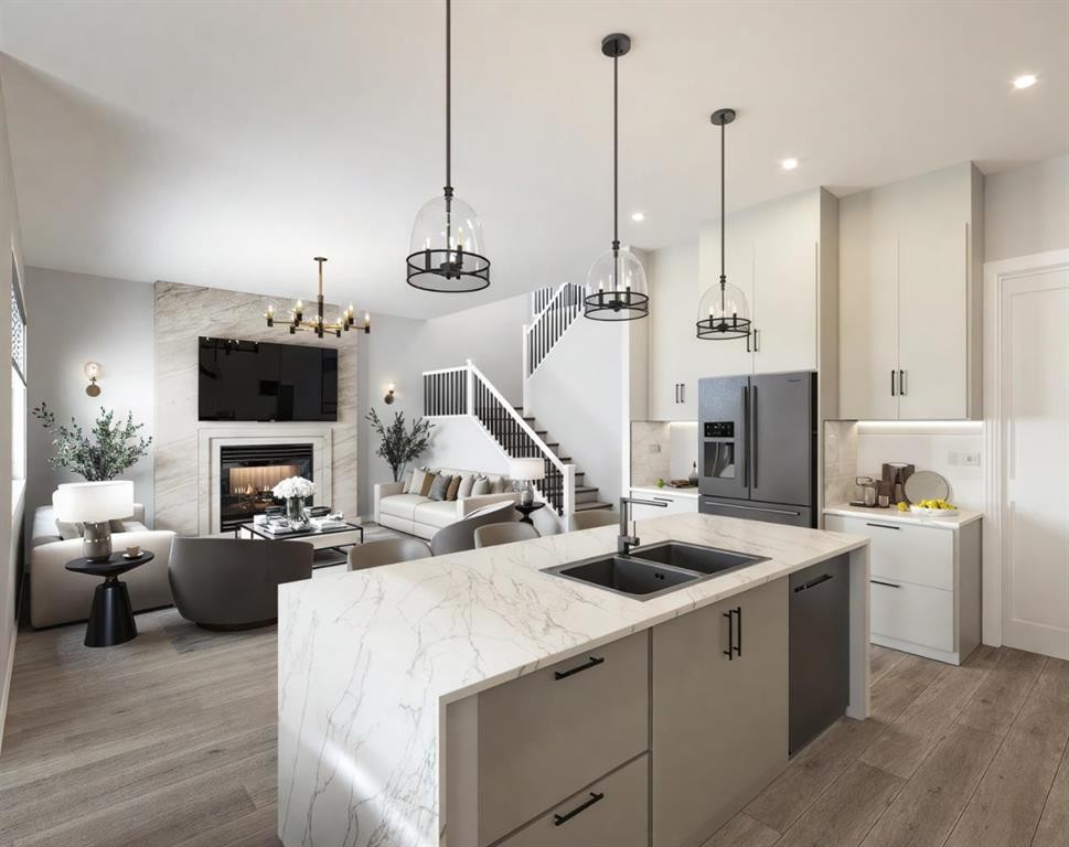14 Bridges Way, Langdon, AB - Indoor Photo Showing Kitchen With Fireplace With Double Sink With Upgraded Kitchen