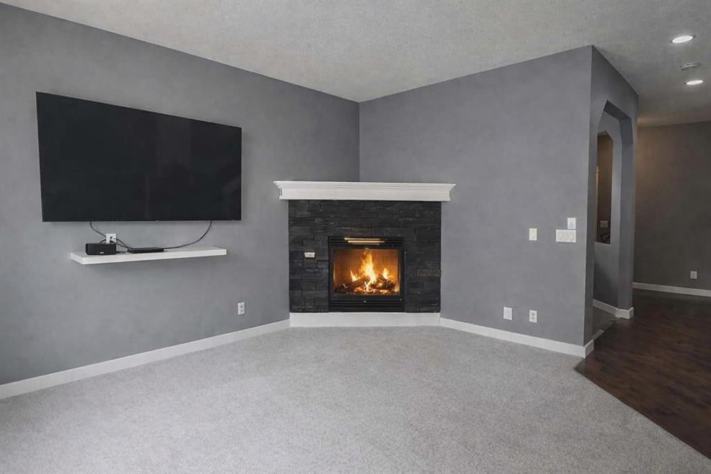 1580 New Brighton Drive Se, Calgary, AB - Indoor Photo Showing Living Room With Fireplace
