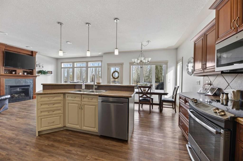 5910 Park Meadows Crescent, Olds, AB - Indoor Photo Showing Kitchen With Fireplace With Double Sink With Upgraded Kitchen