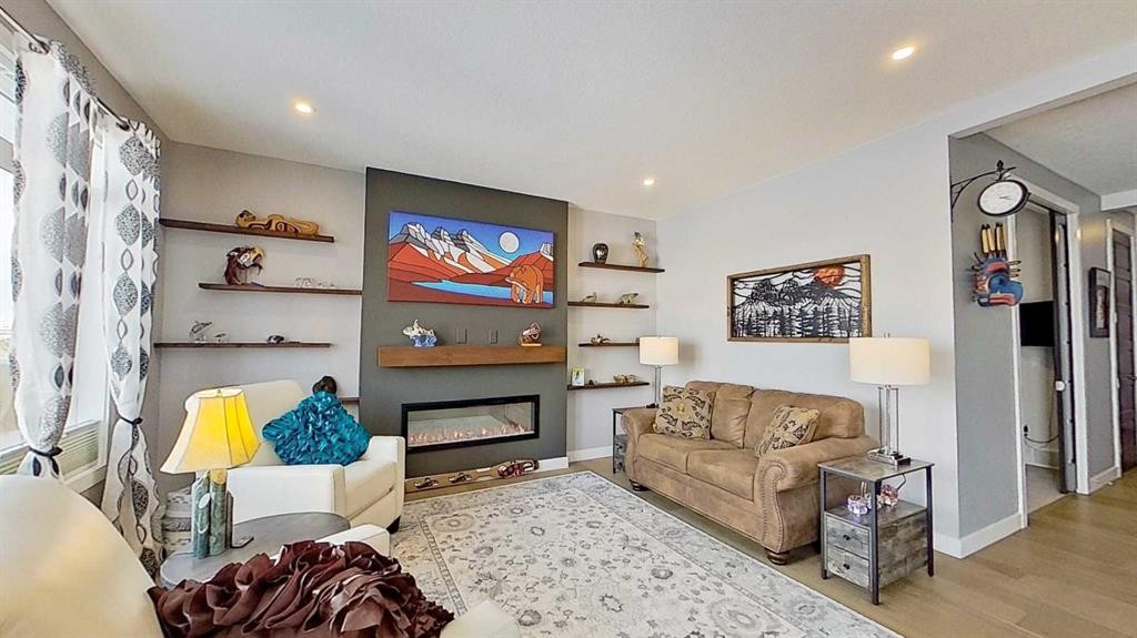 163 Sundown Crescent, Cochrane, AB - Indoor Photo Showing Living Room With Fireplace