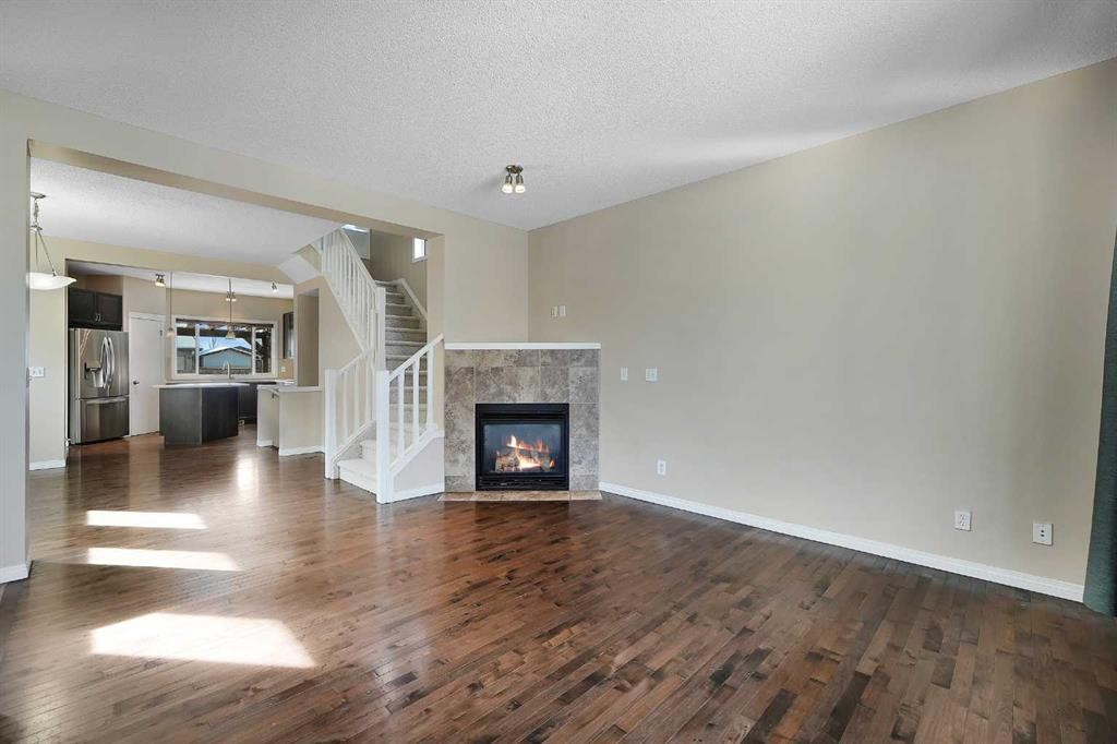 1833 New Brighton Drive Se, Calgary, AB - Indoor Photo Showing Living Room With Fireplace
