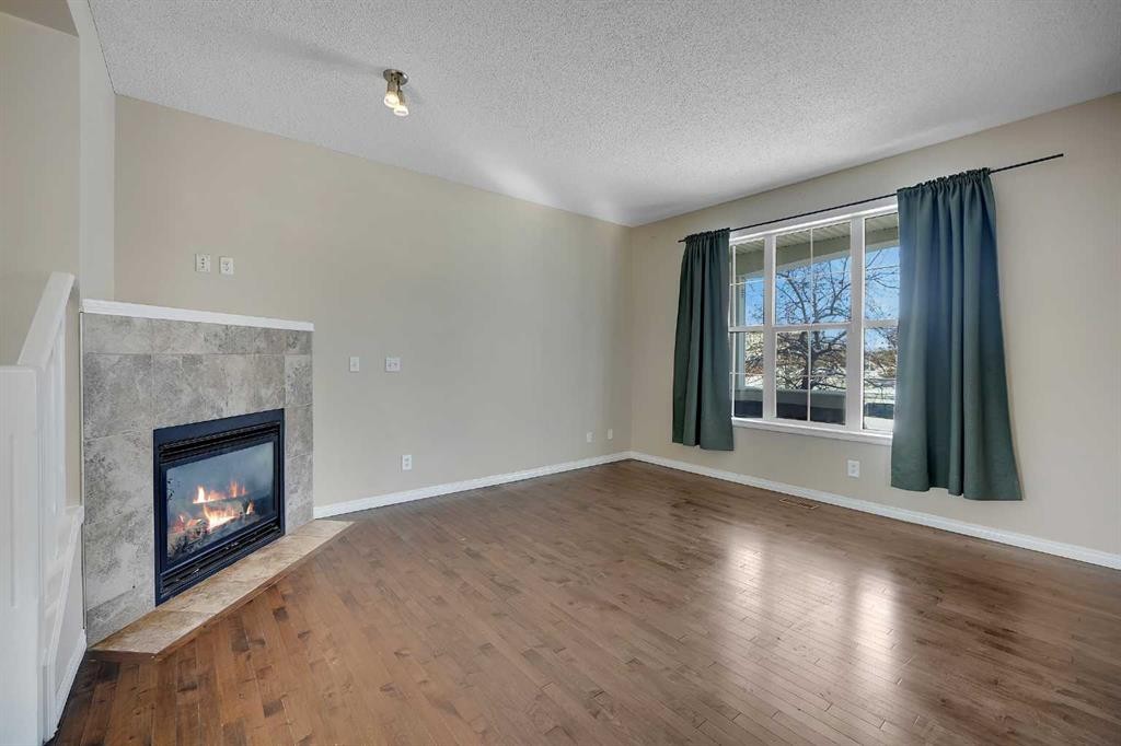 1833 New Brighton Drive Se, Calgary, AB - Indoor Photo Showing Other Room With Fireplace