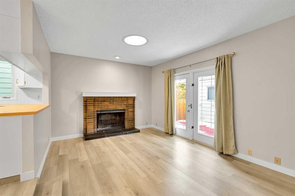 1111 Berkley Drive Nw, Calgary, AB - Indoor Photo Showing Living Room With Fireplace