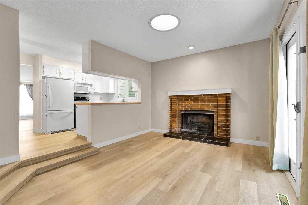 1111 Berkley Drive Nw, Calgary, AB - Indoor Photo Showing Living Room With Fireplace