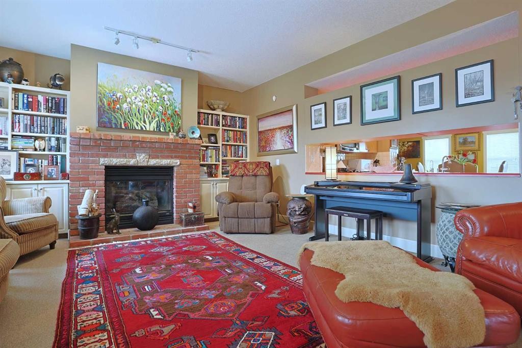 300 Garrison Square Sw, Calgary, AB - Indoor Photo Showing Living Room With Fireplace