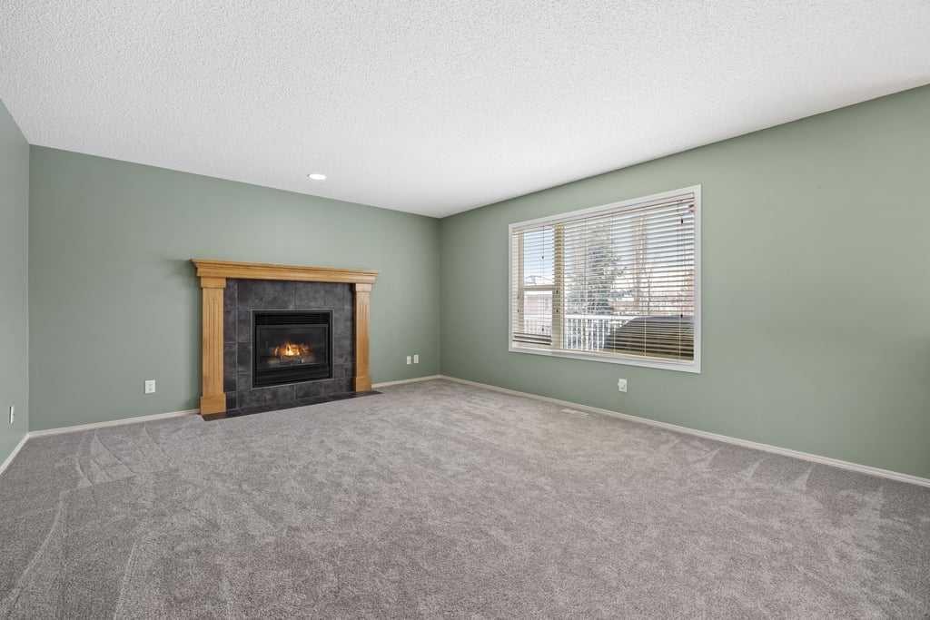 19 Sienna Park Crescent Sw, Calgary, AB - Indoor Photo Showing Living Room With Fireplace
