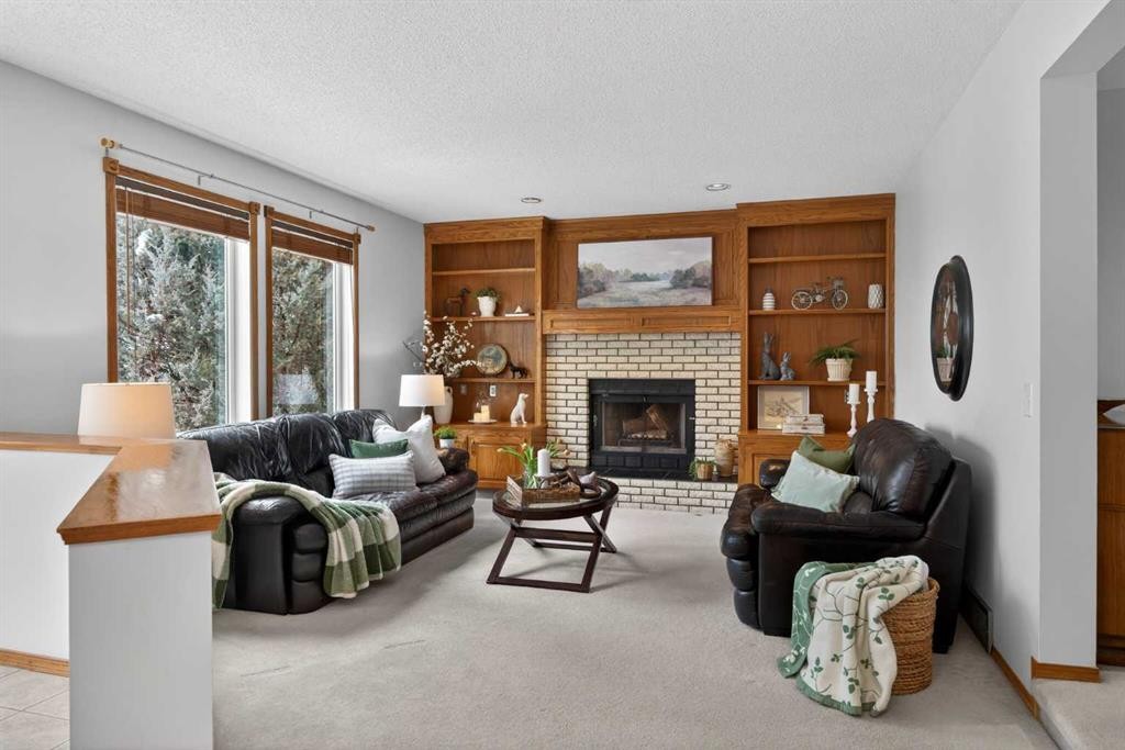 677 Hawkwood Boulevard Nw, Calgary, AB - Indoor Photo Showing Living Room With Fireplace