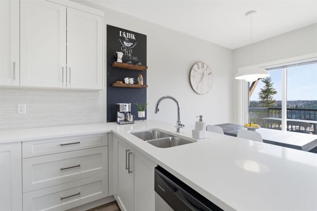 1208 Jumping Pound Common, Cochrane, AB - Indoor Photo Showing Kitchen With Double Sink With Upgraded Kitchen