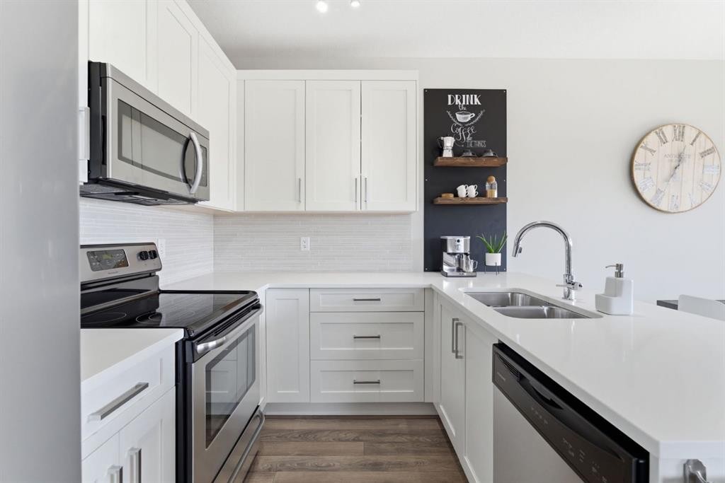 1208 Jumping Pound Common, Cochrane, AB - Indoor Photo Showing Kitchen With Double Sink With Upgraded Kitchen
