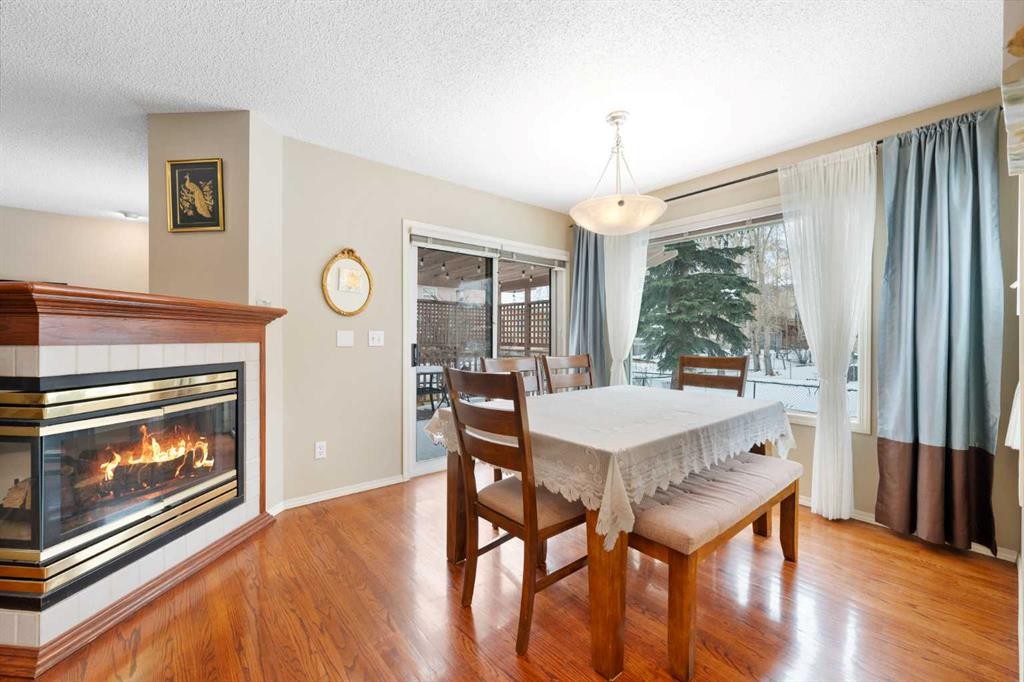 69 Hampstead Gardens Nw, Calgary, AB - Indoor Photo Showing Dining Room With Fireplace