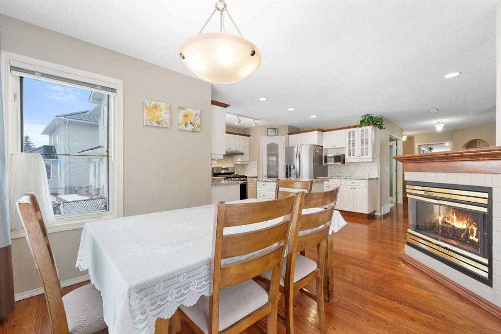 69 Hampstead Gardens Nw, Calgary, AB - Indoor Photo Showing Dining Room With Fireplace