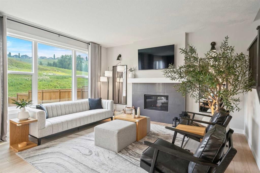 36 Cranbrook Cape Se, Calgary, AB - Indoor Photo Showing Living Room With Fireplace