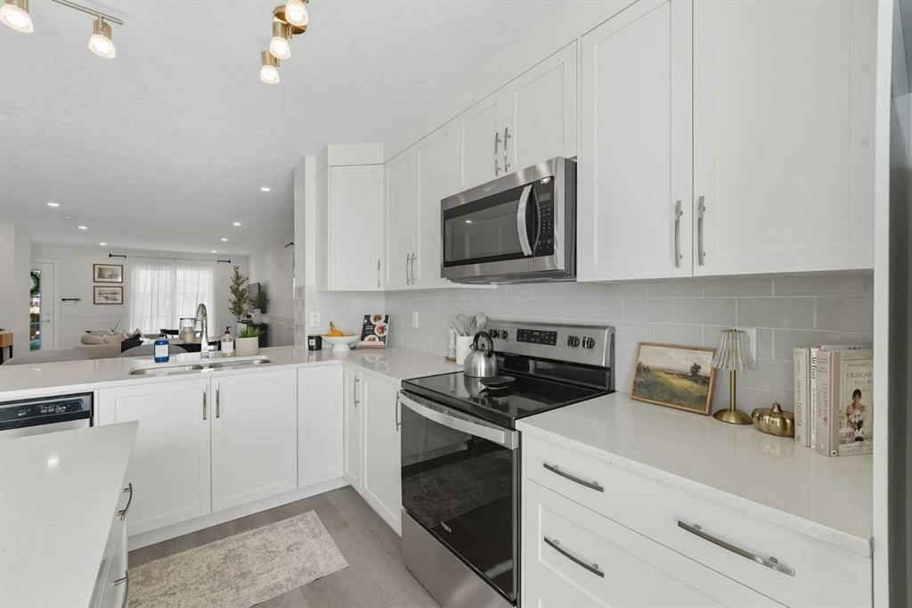 102-474 Seton Circle Se, Calgary, AB - Indoor Photo Showing Kitchen With Double Sink With Upgraded Kitchen