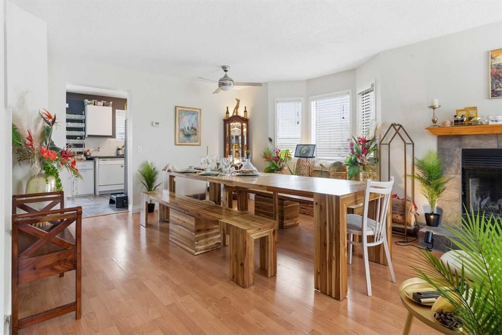 59 Abbeydale Villas Ne, Calgary, AB - Indoor Photo Showing Dining Room With Fireplace