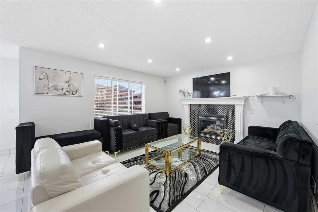 53 Martha'S Place Ne, Calgary, AB - Indoor Photo Showing Living Room With Fireplace