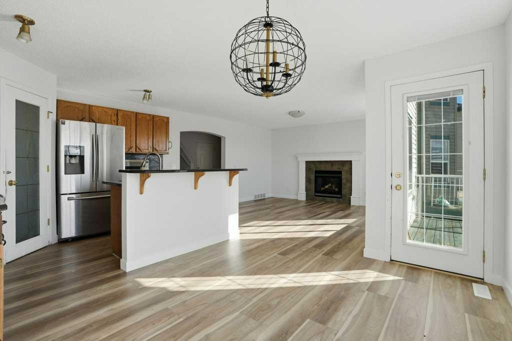 53 Saddlecrest Place Ne, Calgary, AB - Indoor Photo Showing Kitchen With Fireplace