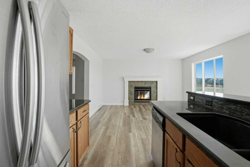 53 Saddlecrest Place Ne, Calgary, AB - Indoor Photo Showing Kitchen With Fireplace