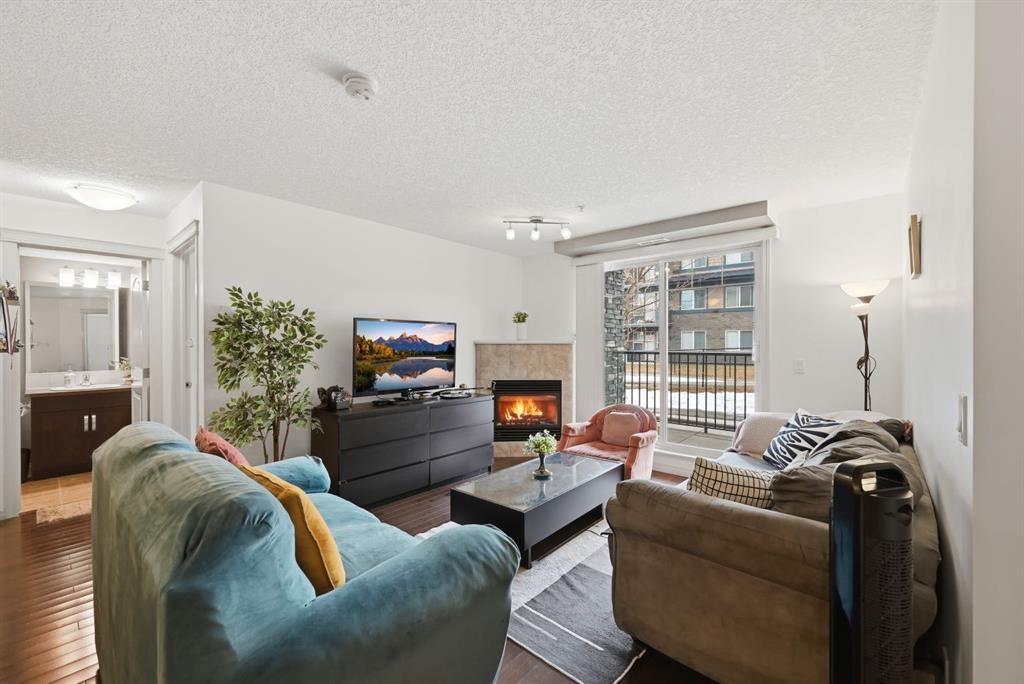 2119-175 Panatella Hill Nw, Calgary, AB - Indoor Photo Showing Living Room With Fireplace