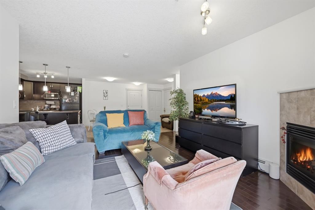 2119-175 Panatella Hill Nw, Calgary, AB - Indoor Photo Showing Living Room With Fireplace