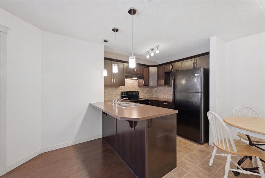 2119-175 Panatella Hill Nw, Calgary, AB - Indoor Photo Showing Kitchen With Double Sink