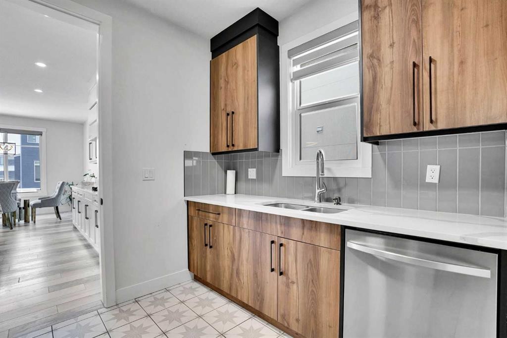 103 Sandpiper Park, Chestermere, AB - Indoor Photo Showing Kitchen With Double Sink